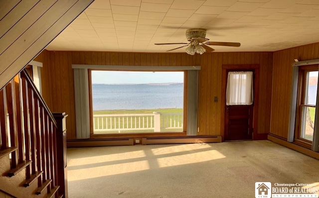 interior space featuring a water view, ceiling fan, and a baseboard radiator