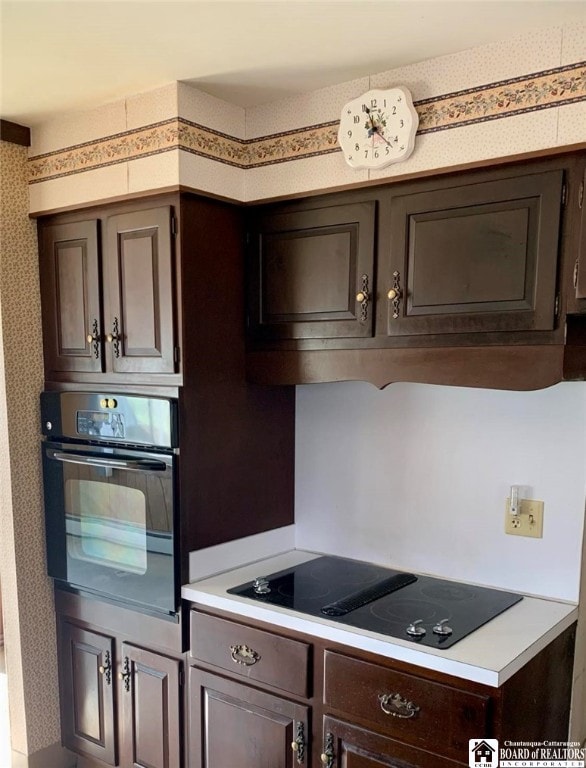 kitchen with dark brown cabinets and black appliances