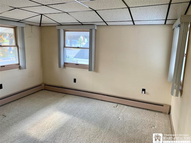 unfurnished room featuring carpet and a paneled ceiling