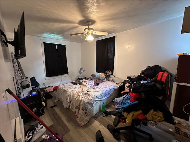 bedroom with ceiling fan and wood-type flooring