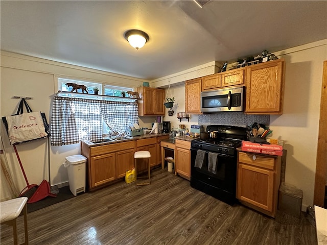 kitchen with sink, dark hardwood / wood-style floors, and black range oven