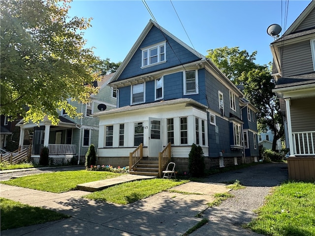 view of front of property with a front yard and covered porch