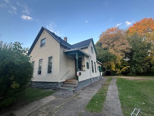 356 4th St, Rochester, NY 14605 - view of home's exterior featuring a chimney and a yard