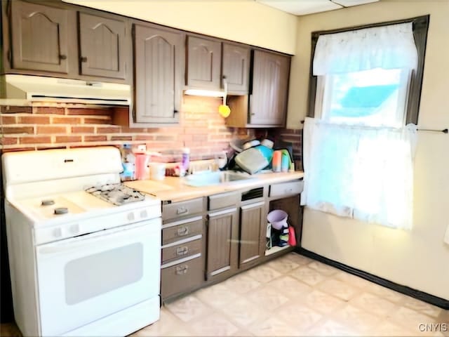 kitchen featuring sink and white gas range oven