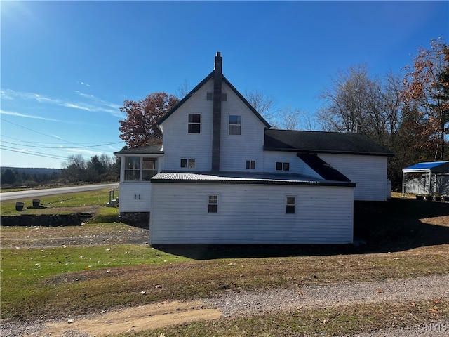 back of property with a lawn