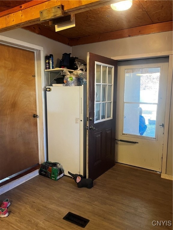 entryway with dark hardwood / wood-style flooring