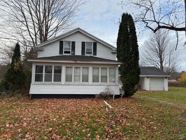 view of side of home featuring a garage and an outdoor structure