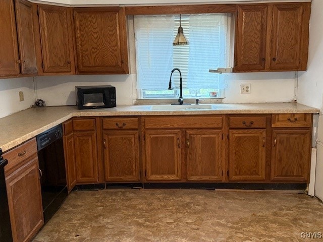 kitchen with sink, black appliances, and decorative light fixtures