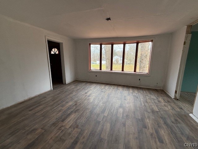 empty room with dark hardwood / wood-style floors