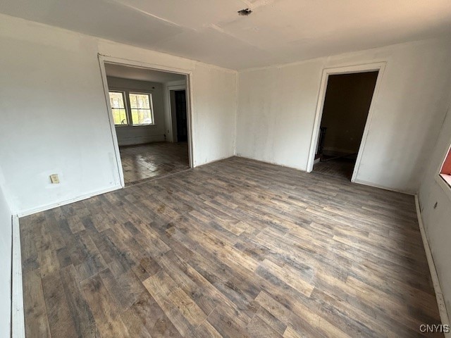 spare room featuring dark hardwood / wood-style flooring