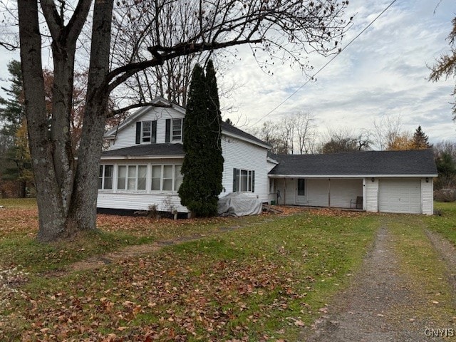 view of front of home featuring a garage and a sunroom