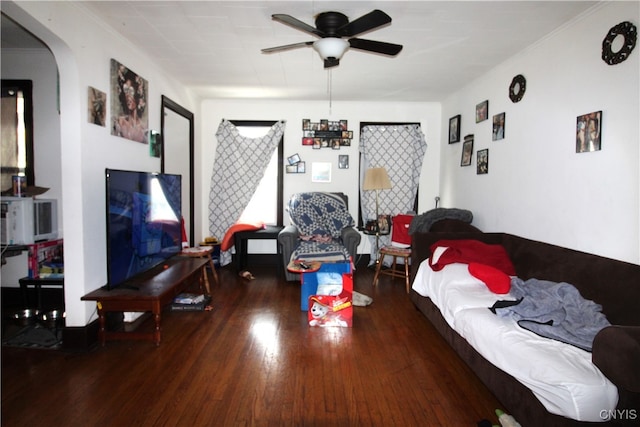 living room with ceiling fan and dark hardwood / wood-style flooring