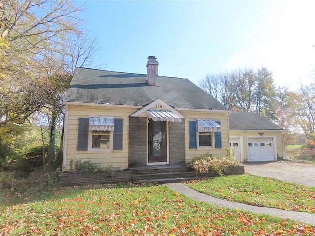 bungalow-style home featuring a garage and a front yard