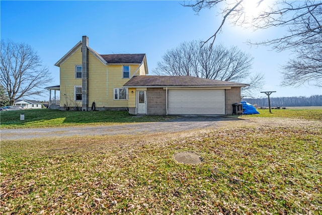 view of front facade with a garage and a front yard