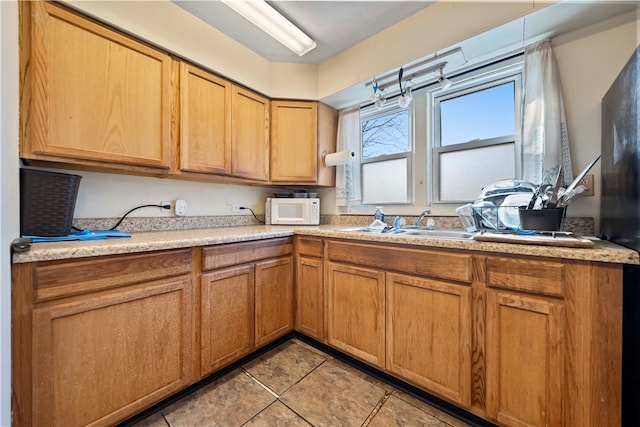 kitchen featuring light tile patterned flooring and sink