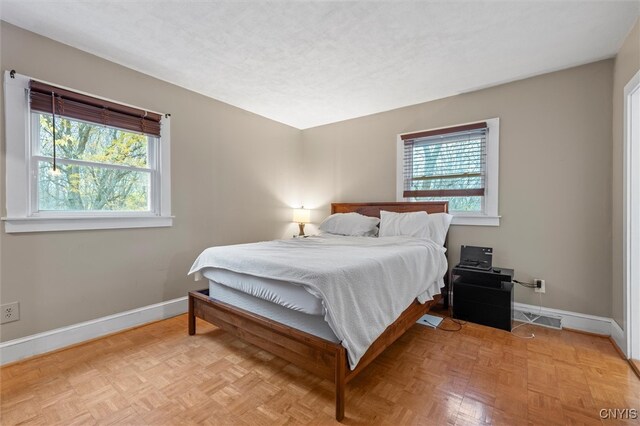 bedroom with light parquet floors