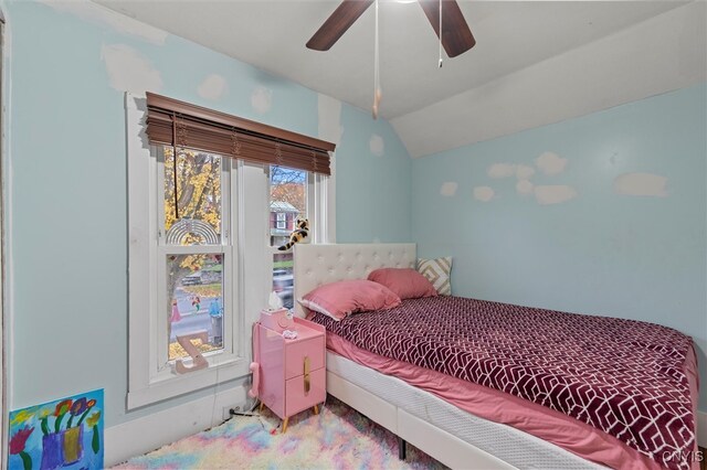 bedroom with lofted ceiling, ceiling fan, and carpet floors