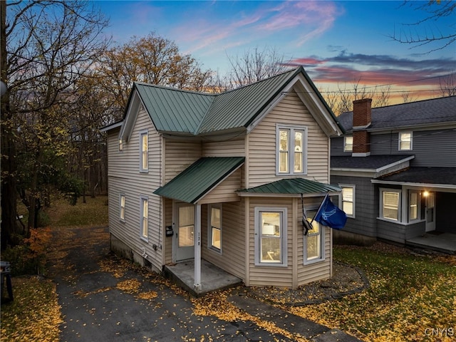 view of back house at dusk