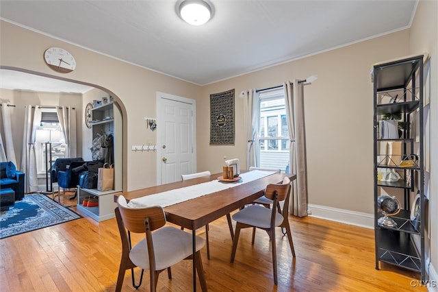 dining space featuring hardwood / wood-style floors and ornamental molding