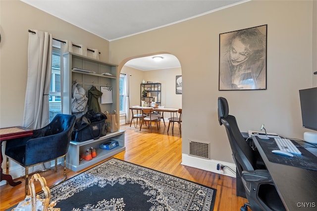 office with hardwood / wood-style flooring and crown molding