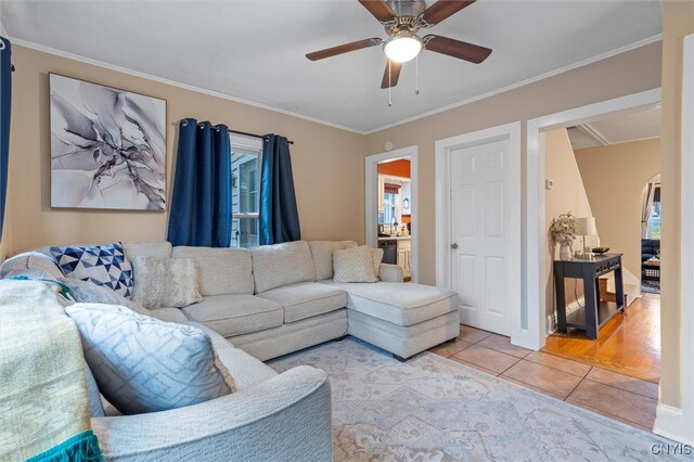 living room with ceiling fan, light hardwood / wood-style flooring, and ornamental molding