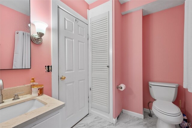 bathroom featuring toilet and vanity