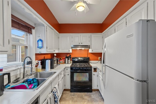 kitchen with sink, ceiling fan, white cabinets, black gas stove, and white fridge