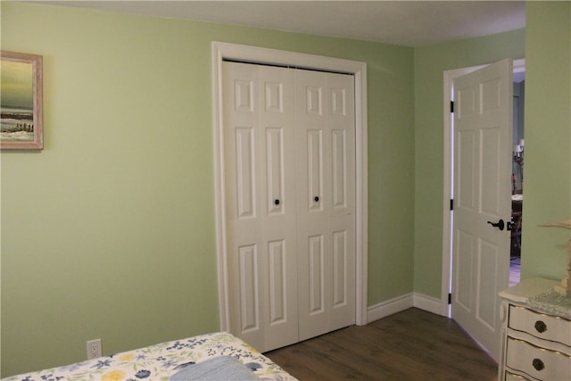 bedroom with a closet and dark hardwood / wood-style floors