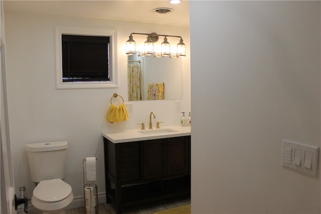 bathroom featuring tile patterned floors, vanity, and toilet