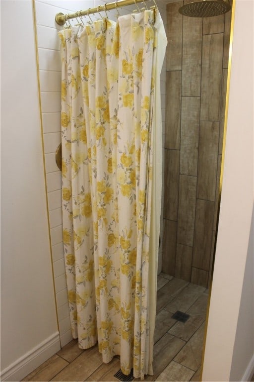 bathroom featuring a shower with curtain and hardwood / wood-style flooring