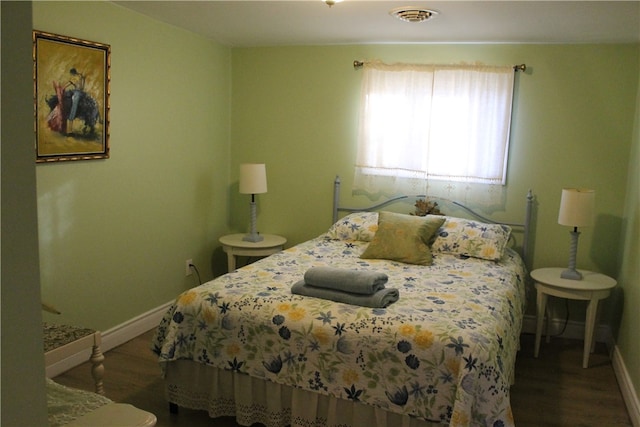 bedroom with wood-type flooring