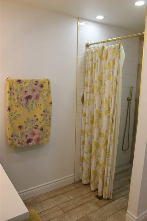 bathroom with wood-type flooring and a shower with shower curtain