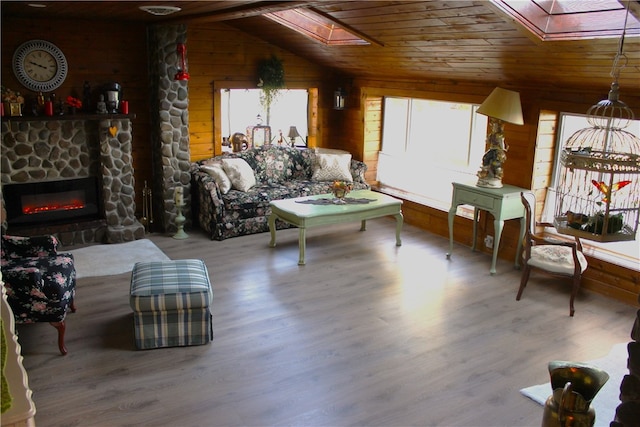 sitting room with a wealth of natural light, wood-type flooring, and wood ceiling