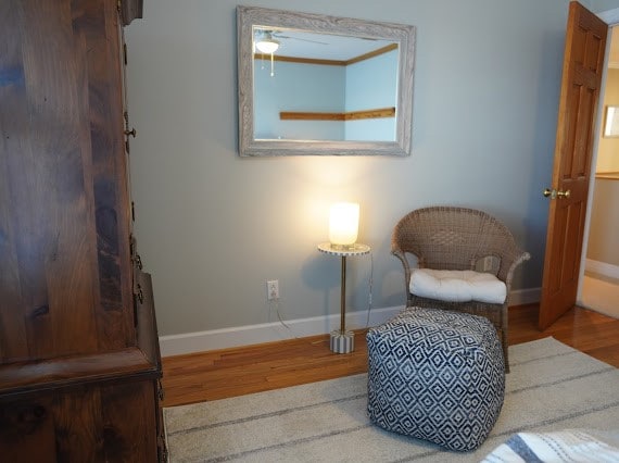 sitting room with hardwood / wood-style floors and ceiling fan