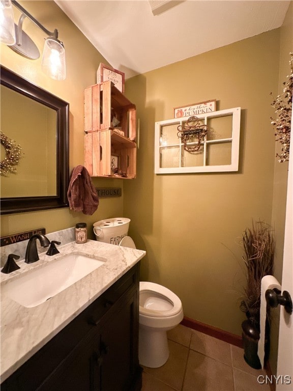 bathroom with tile patterned flooring, vanity, and toilet