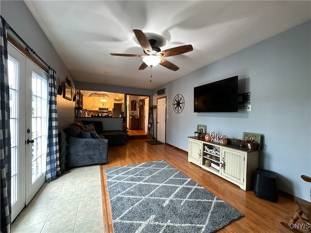 living room featuring french doors, hardwood / wood-style flooring, and ceiling fan