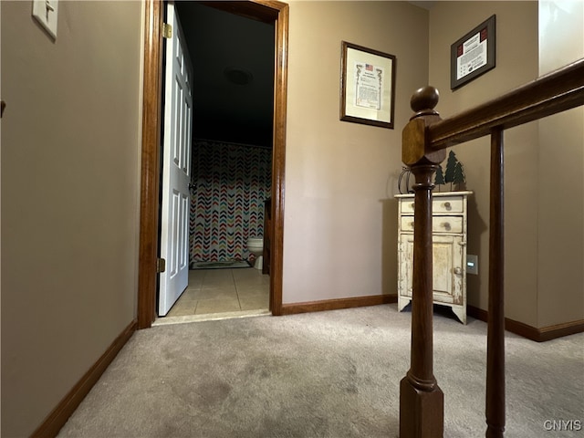 hall with light colored carpet