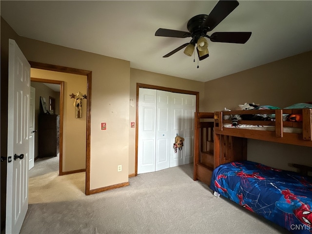 bedroom with light carpet, ceiling fan, and a closet