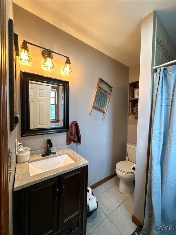 bathroom with tile patterned flooring, curtained shower, vanity, and toilet