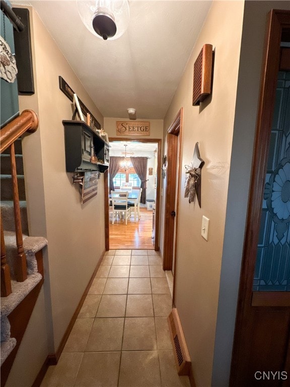 hall featuring light tile patterned floors