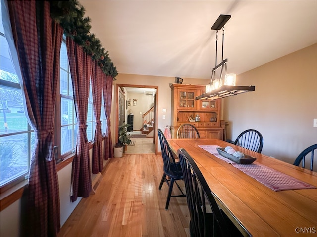 dining space featuring an inviting chandelier and light hardwood / wood-style floors