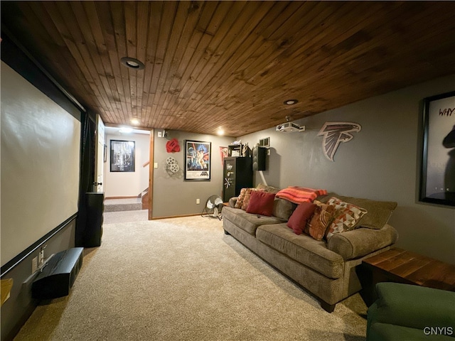 carpeted home theater room featuring wooden ceiling