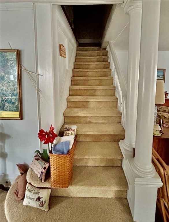 staircase featuring decorative columns