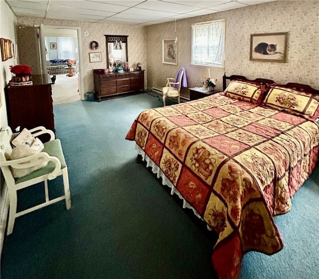 carpeted bedroom featuring a paneled ceiling