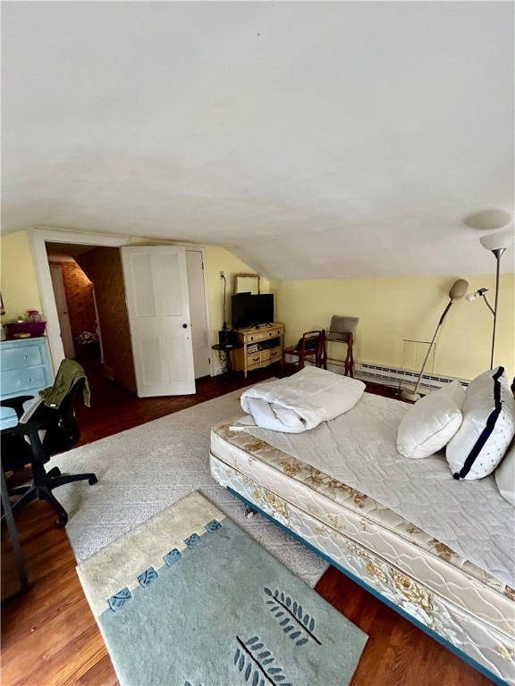 bedroom with baseboard heating, wood-type flooring, and lofted ceiling