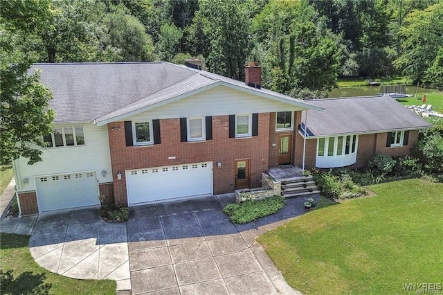 view of front of house with a garage and a front lawn