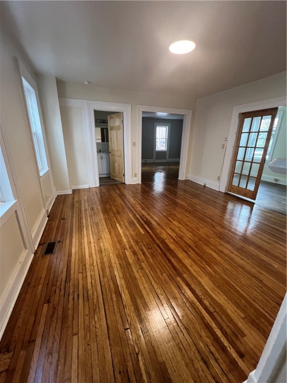 unfurnished living room featuring dark hardwood / wood-style floors