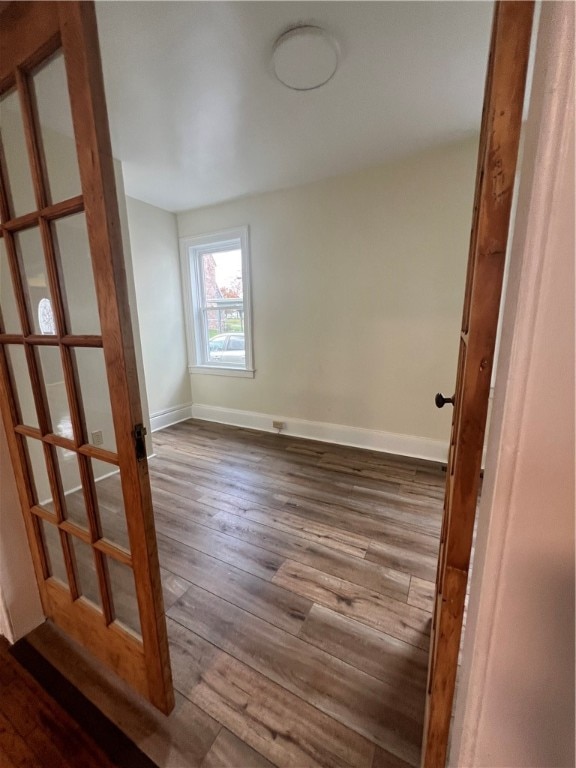 spare room with hardwood / wood-style flooring