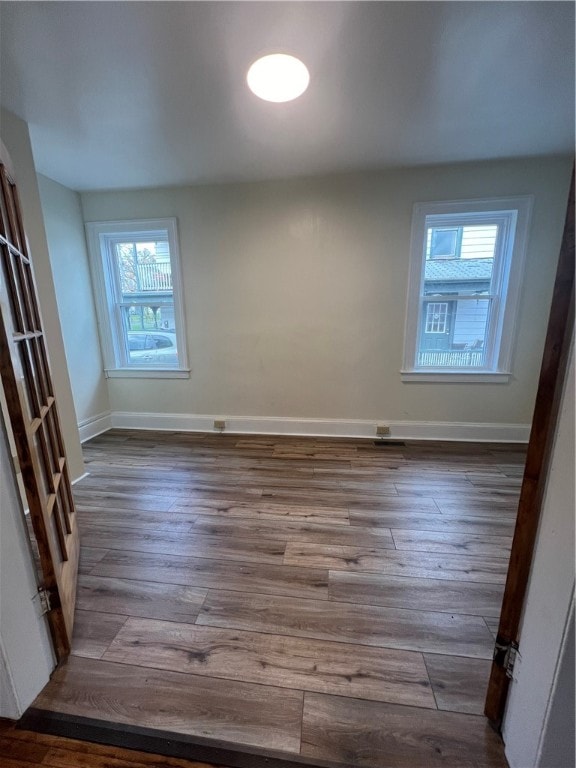 spare room featuring hardwood / wood-style floors and a wealth of natural light