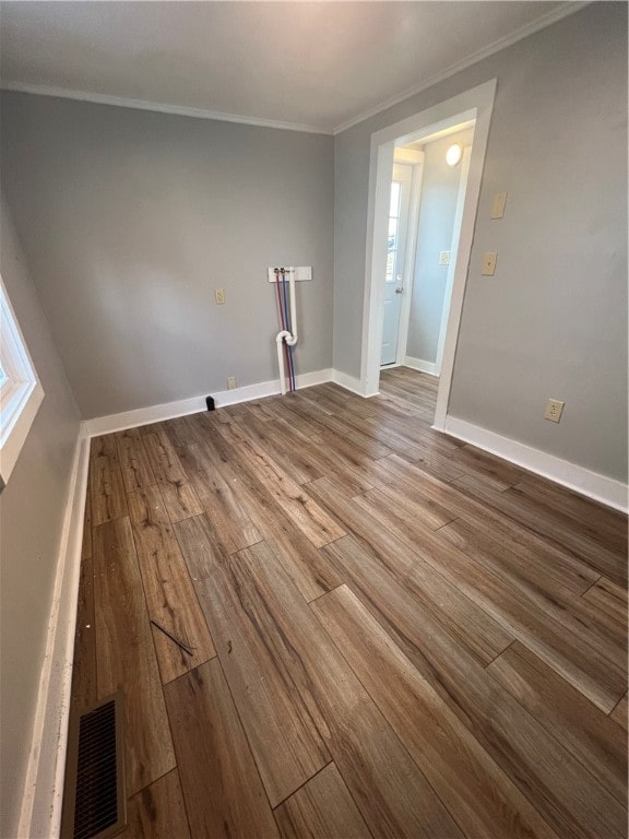 unfurnished room with hardwood / wood-style floors and ornamental molding